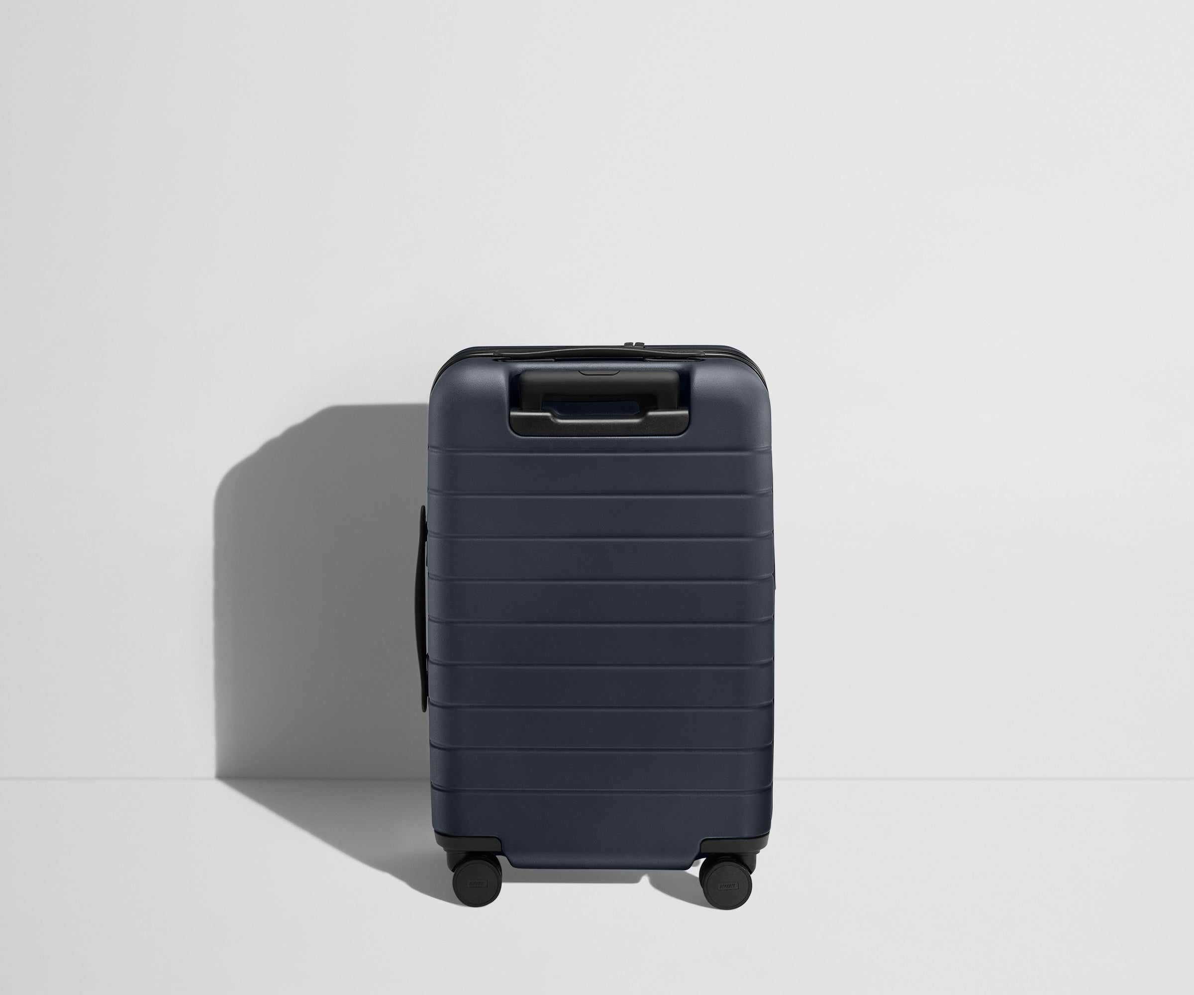 Back product view of The Carry-On Flex suitcase in Navy Blue