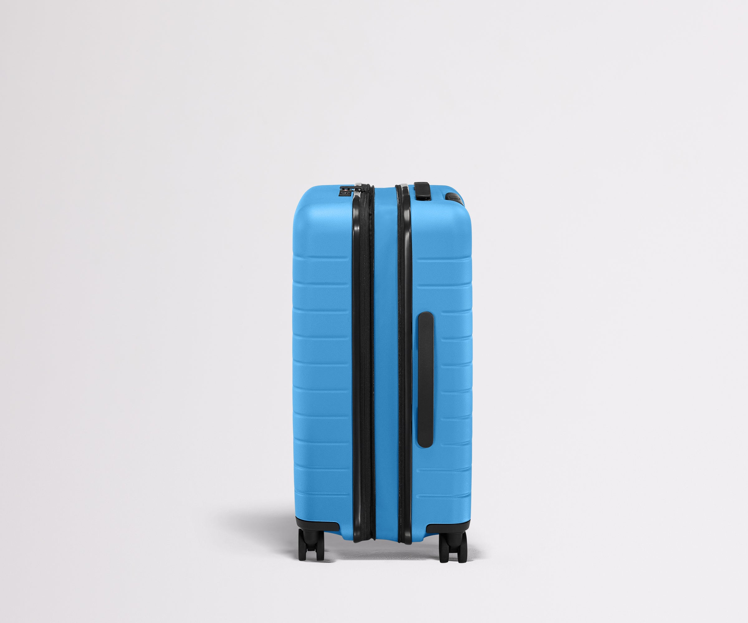 Side product view of The Bigger Carry-On Flex suitcase in Splash Blue shown fully expanded