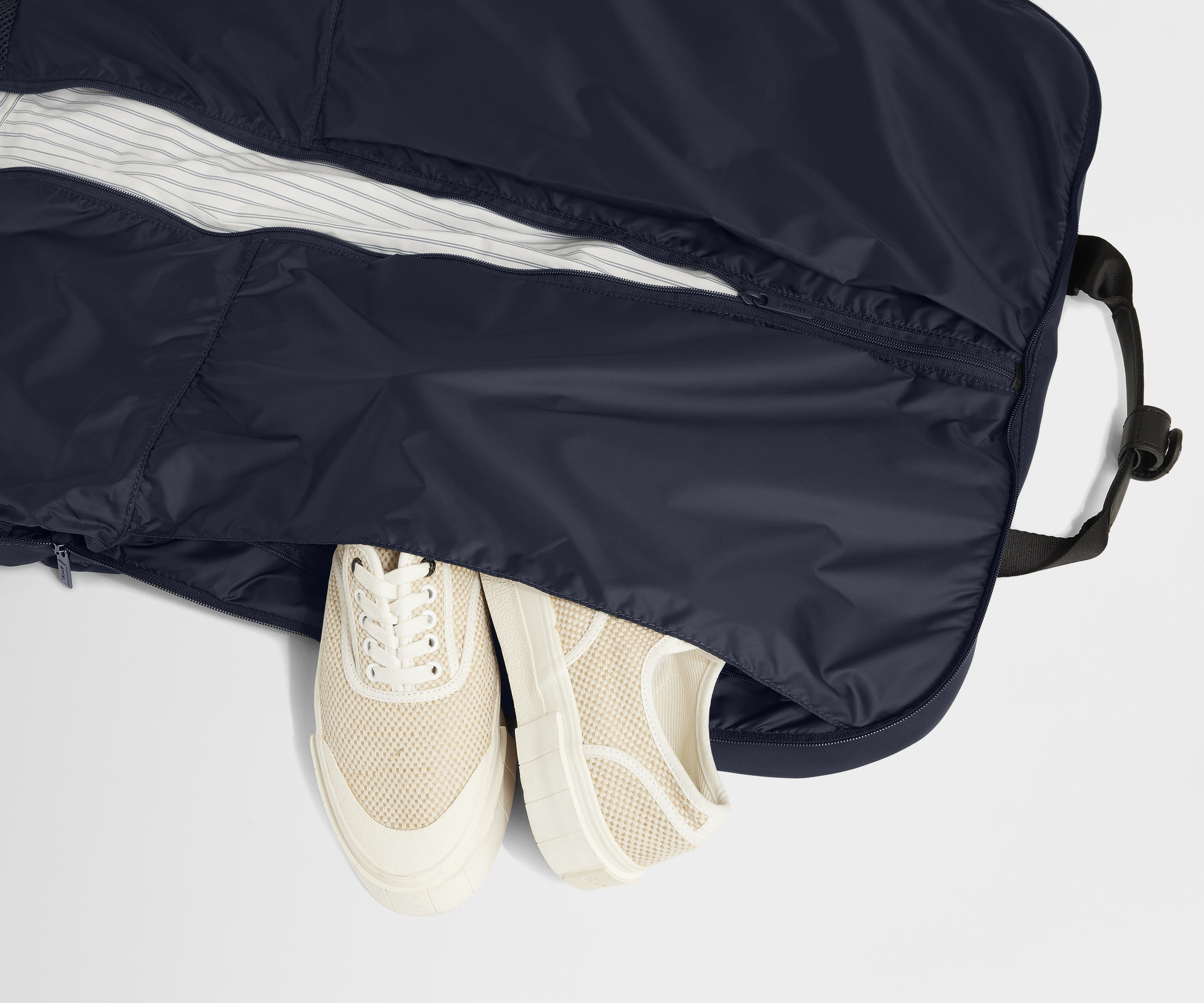 Showing one of two dedicated shoe pockets of the Garment Bag in Navy Blue