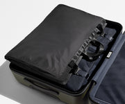 Folded Garment Sleeve clipped inside a checked suitcase