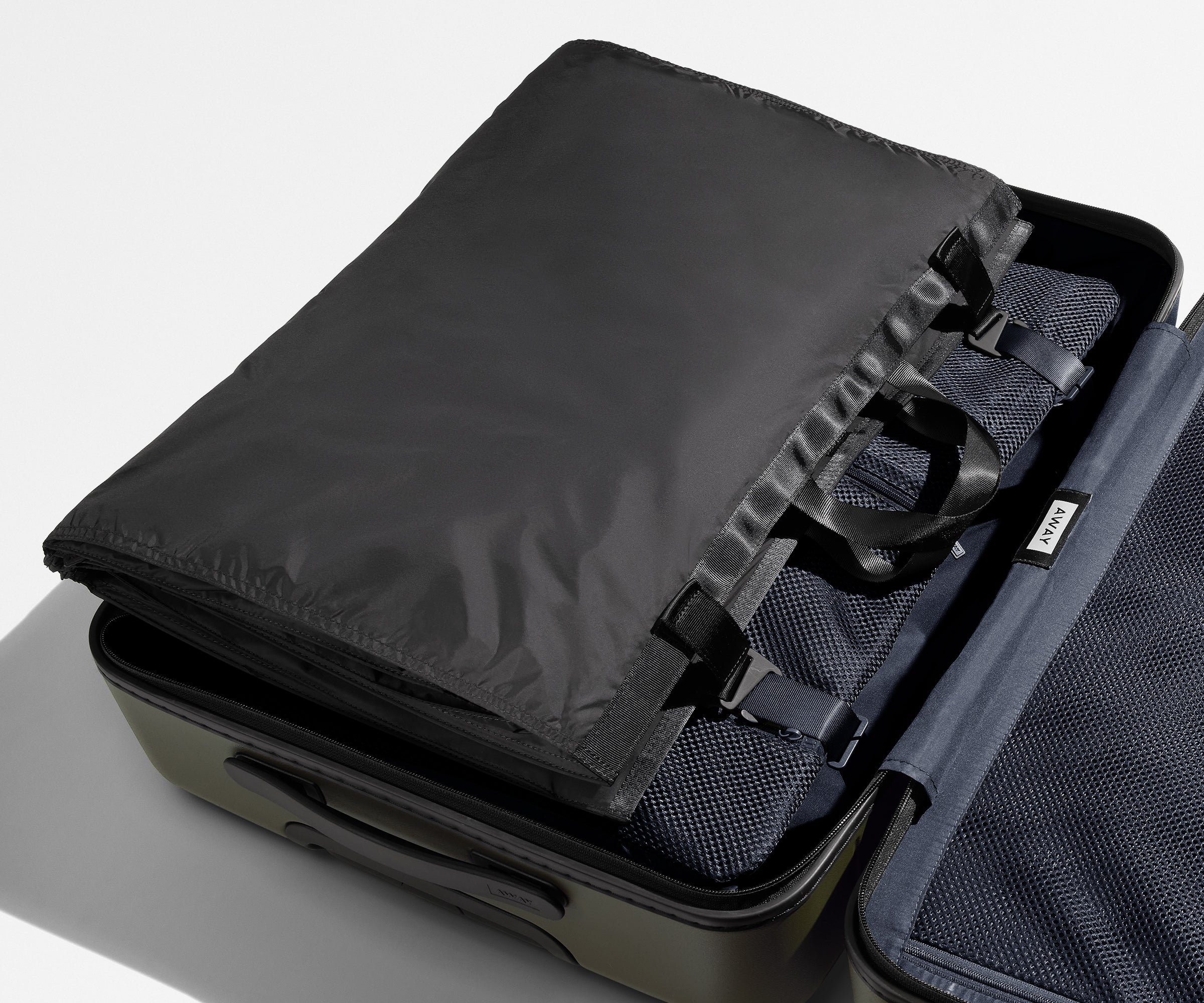 Folded Garment Sleeve clipped inside a checked suitcase