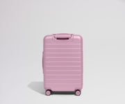 Pink suitcase on a light gray background