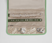 Close up view of the compartments and two padded holders for earrings and rings