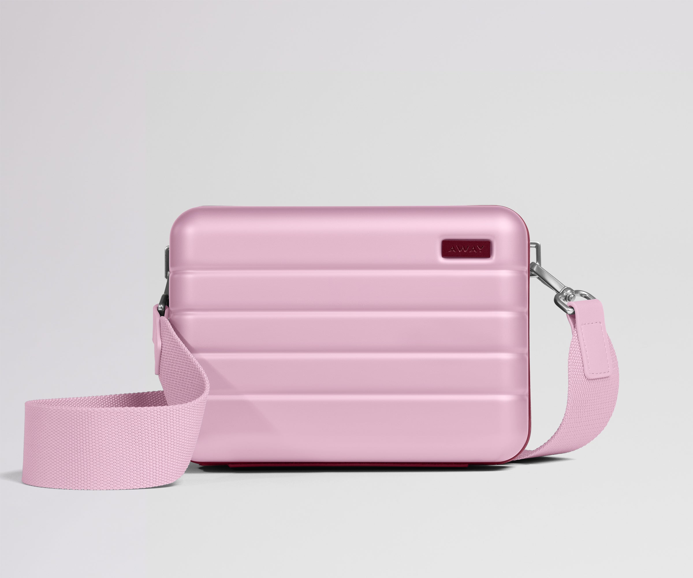 Pink crossbody bag on a light gray background