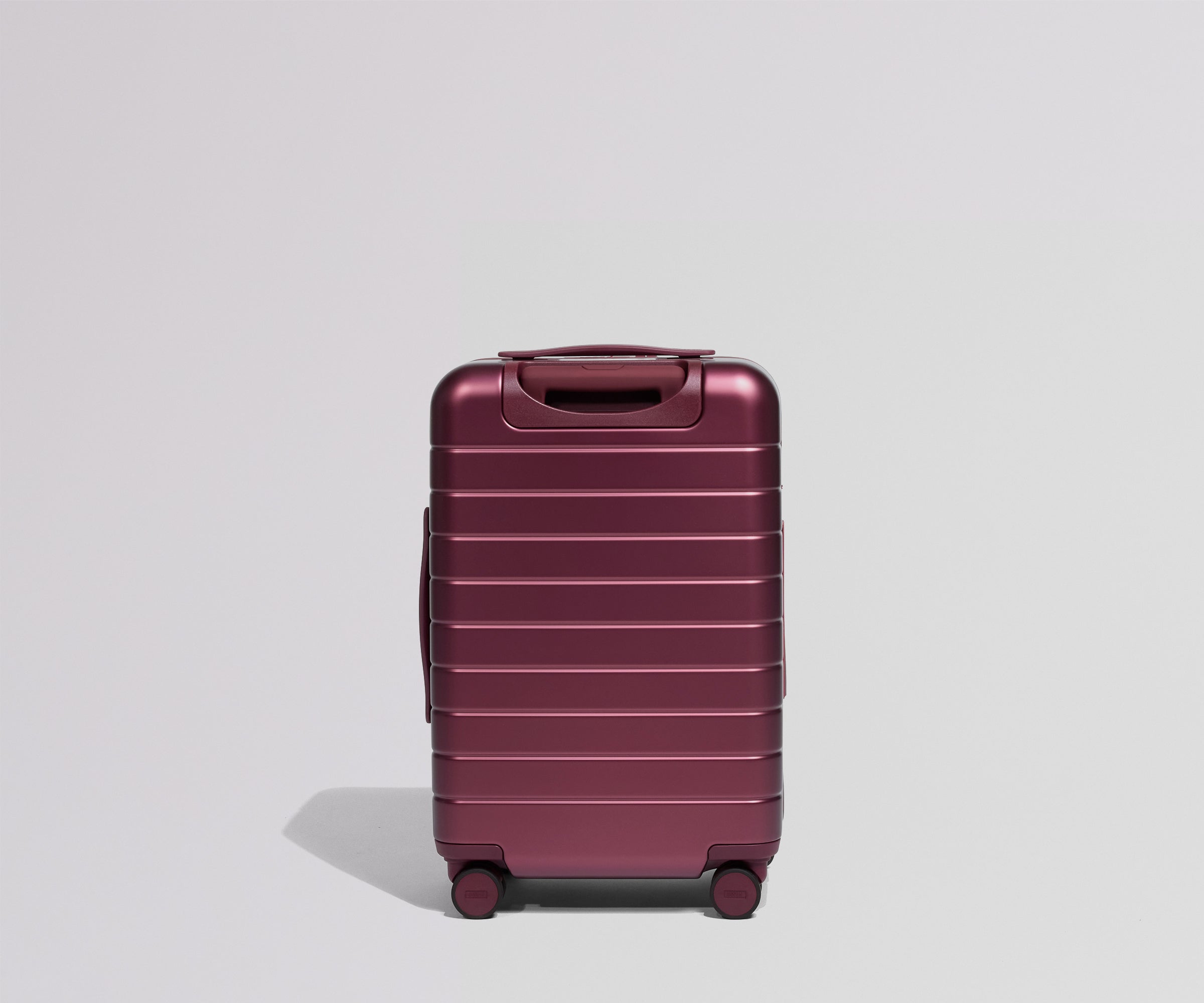 Maroon suitcase on a light gray background