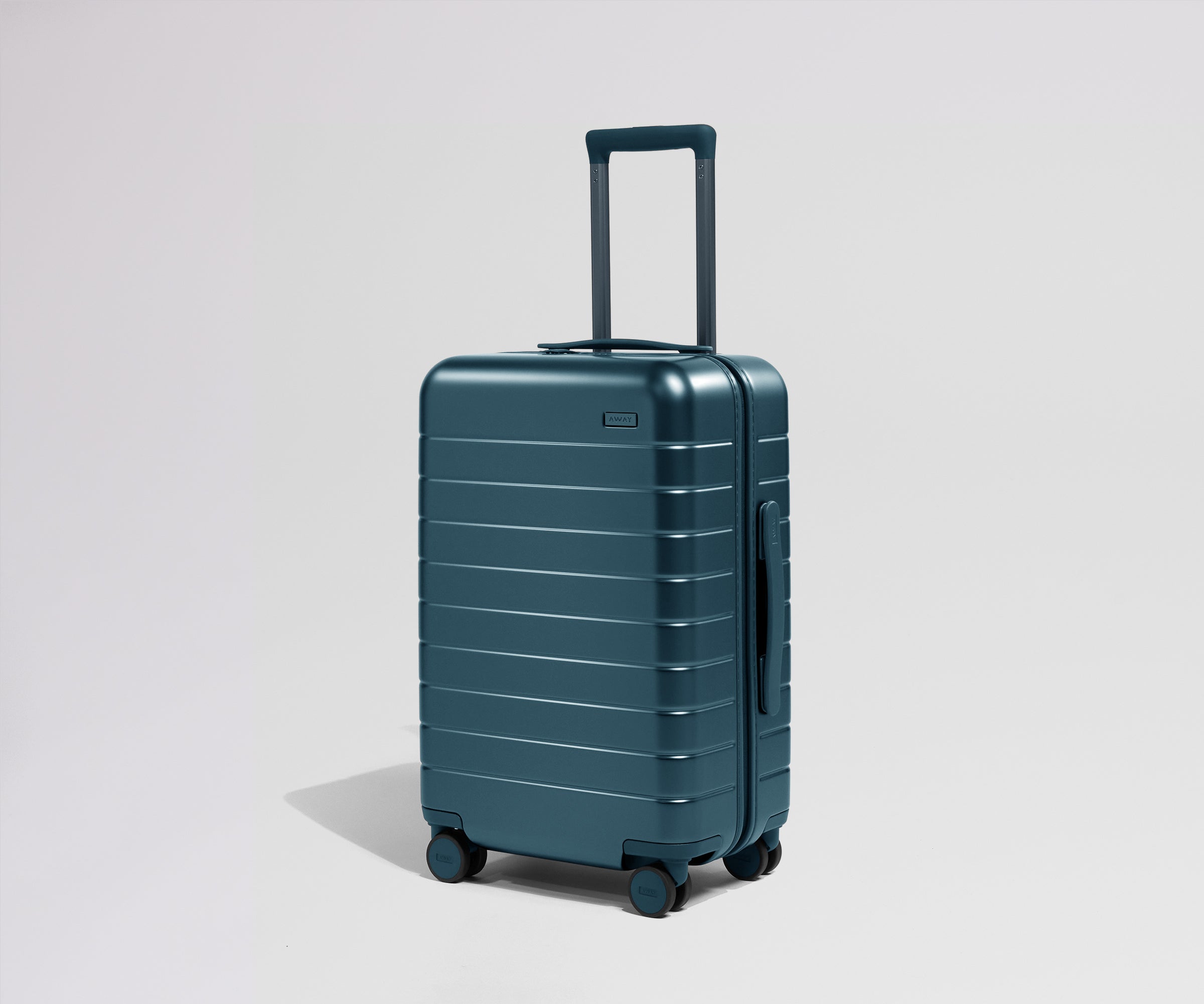 Teal suitcase with a handle on a light gray background