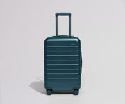 Teal suitcase on a light gray background