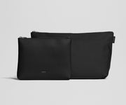 Two black pouches on a light gray background
