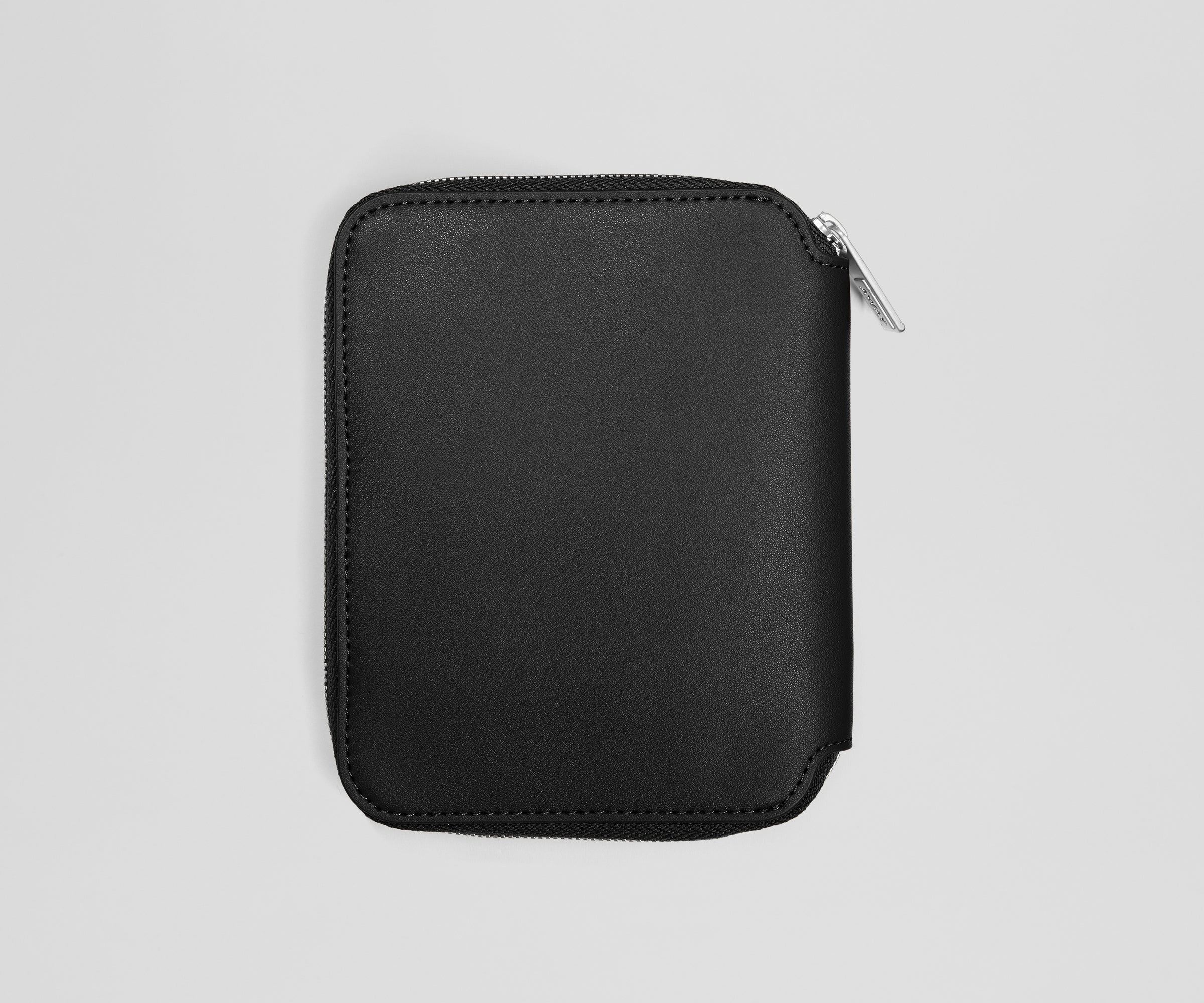 Black leather zippered jewelry case on a light gray background