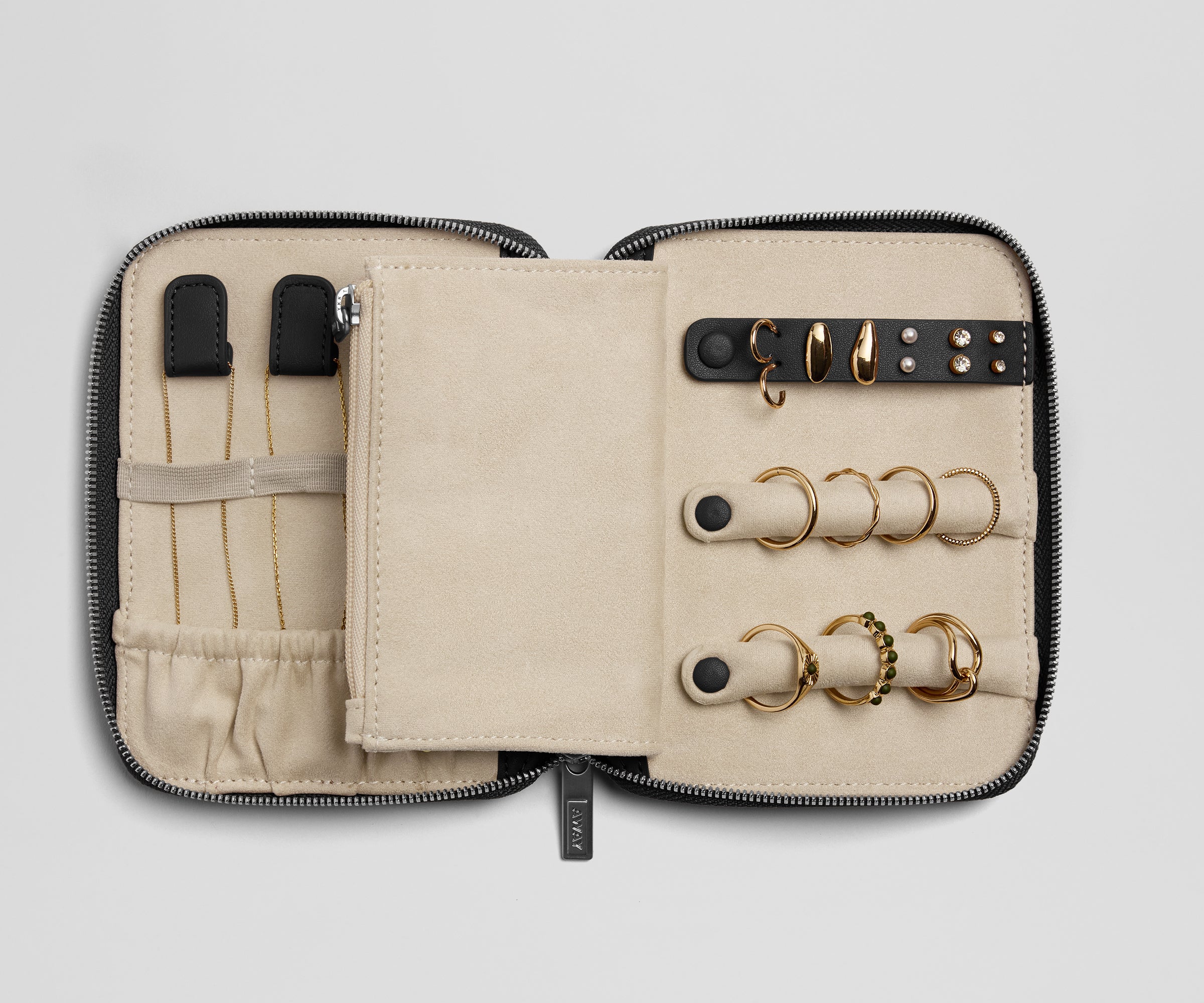 Jewelry case with gold rings on a light gray background
