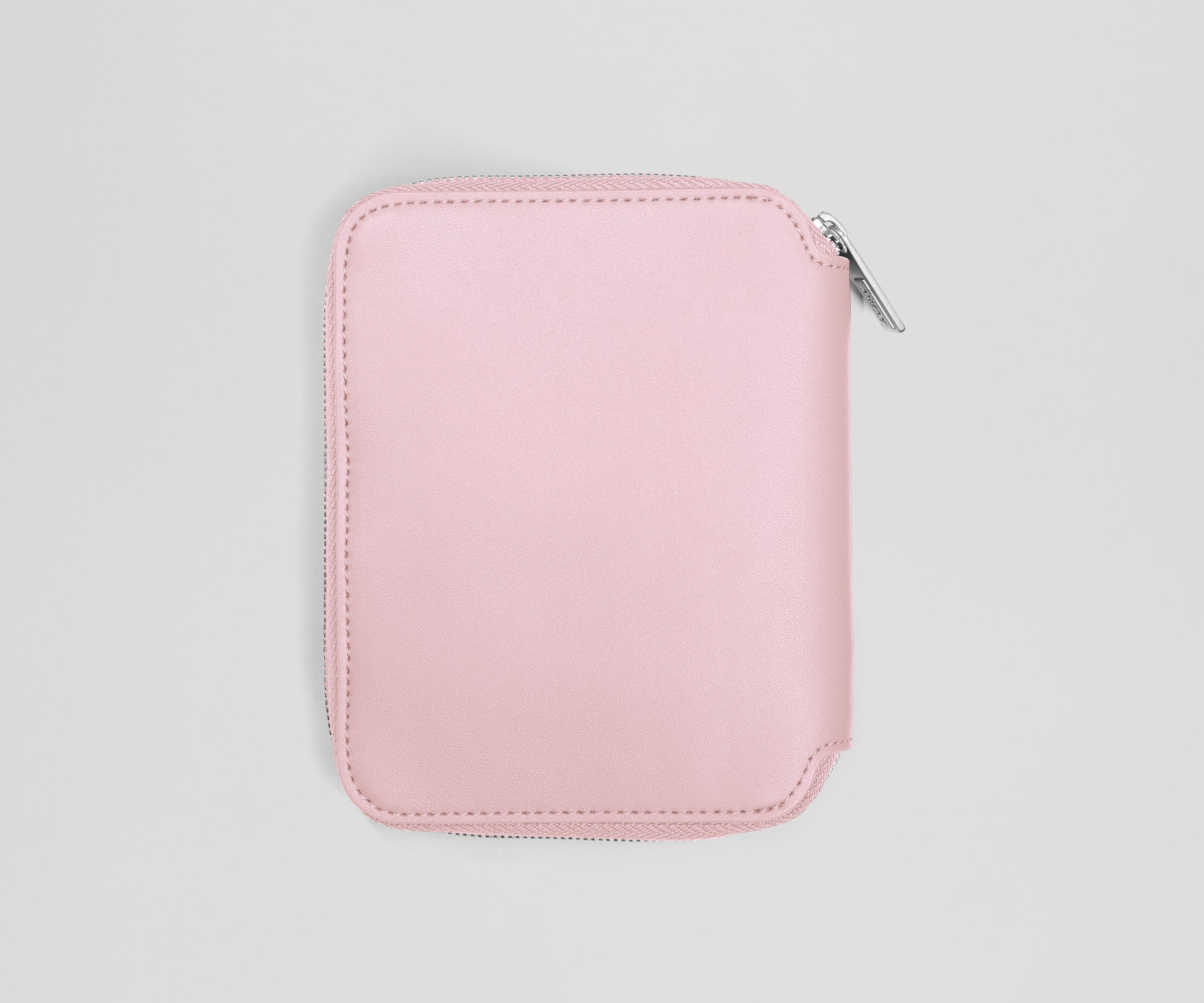 Pink zippered jewelry case on a light gray background