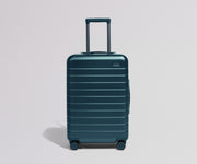 Teal suitcase on a light gray background