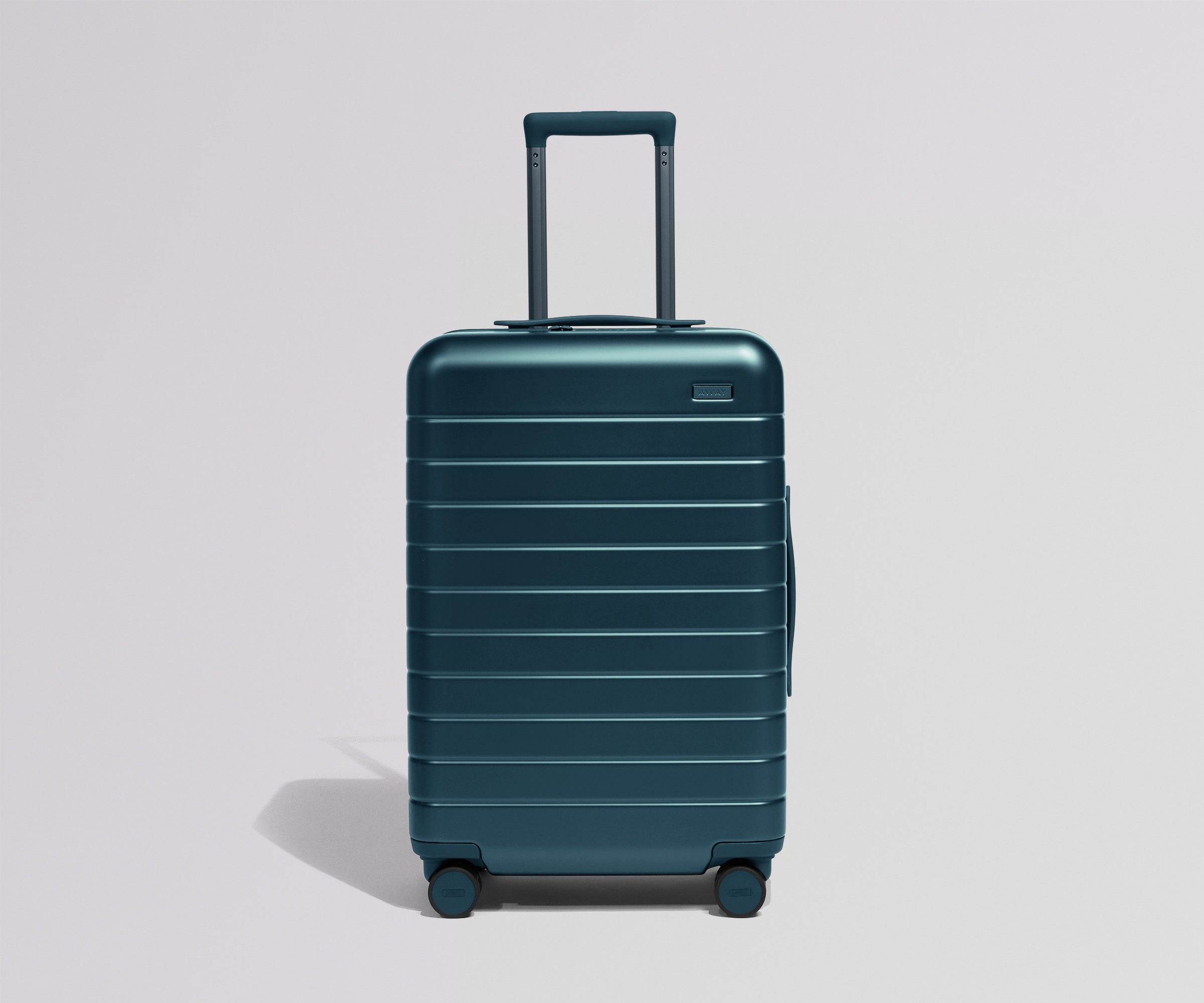 Teal suitcase on a light gray background