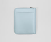Light blue zippered leather wallet on a light gray background