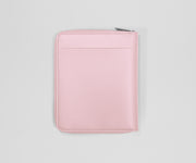 Pink travel wallet on a light gray background