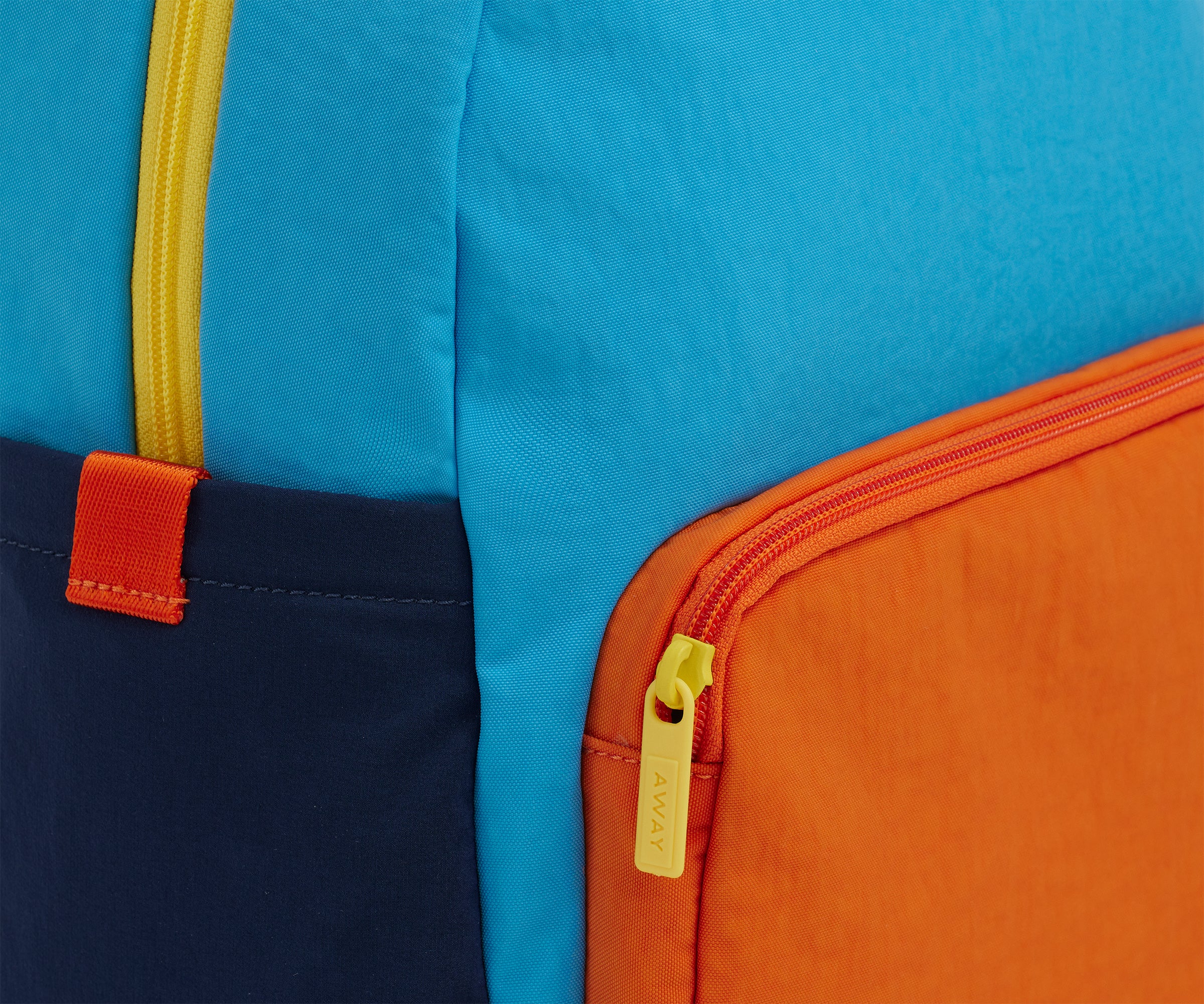 A close up shot of the Kids Backpack in Splash Blue to show the colorblocked details and machine-washable material