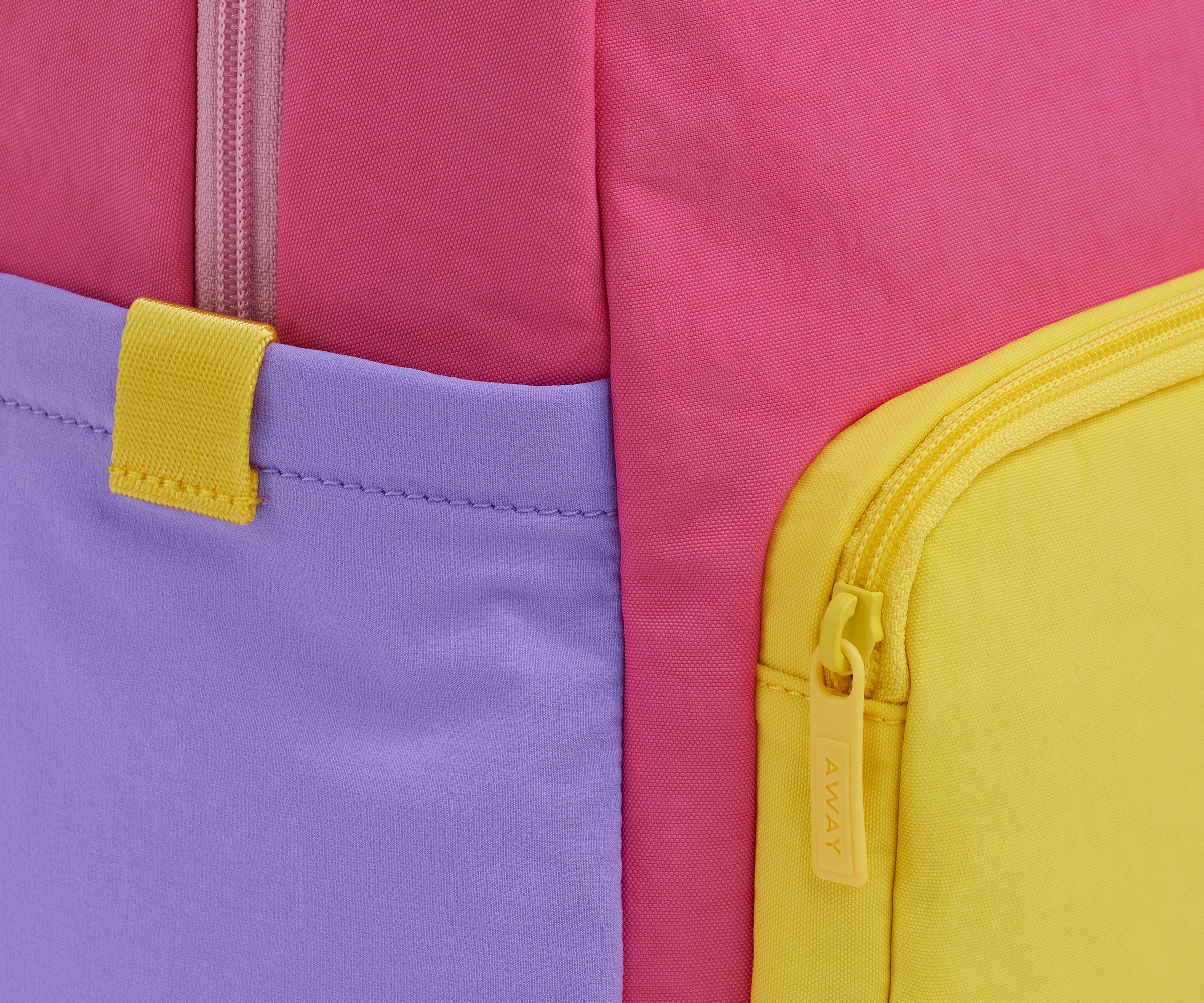 A close up shot of the Kids Backpack in Cotton Candy Pink to show the colorblocked details and machine-washable material