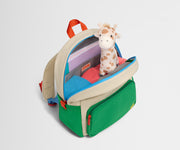Top down product view of the packed Kids Backpack in Marshmallow White, showing how it fits clothes, tablet, notebook and headphones.