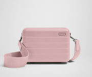 Pink crossbody bag on a light gray background