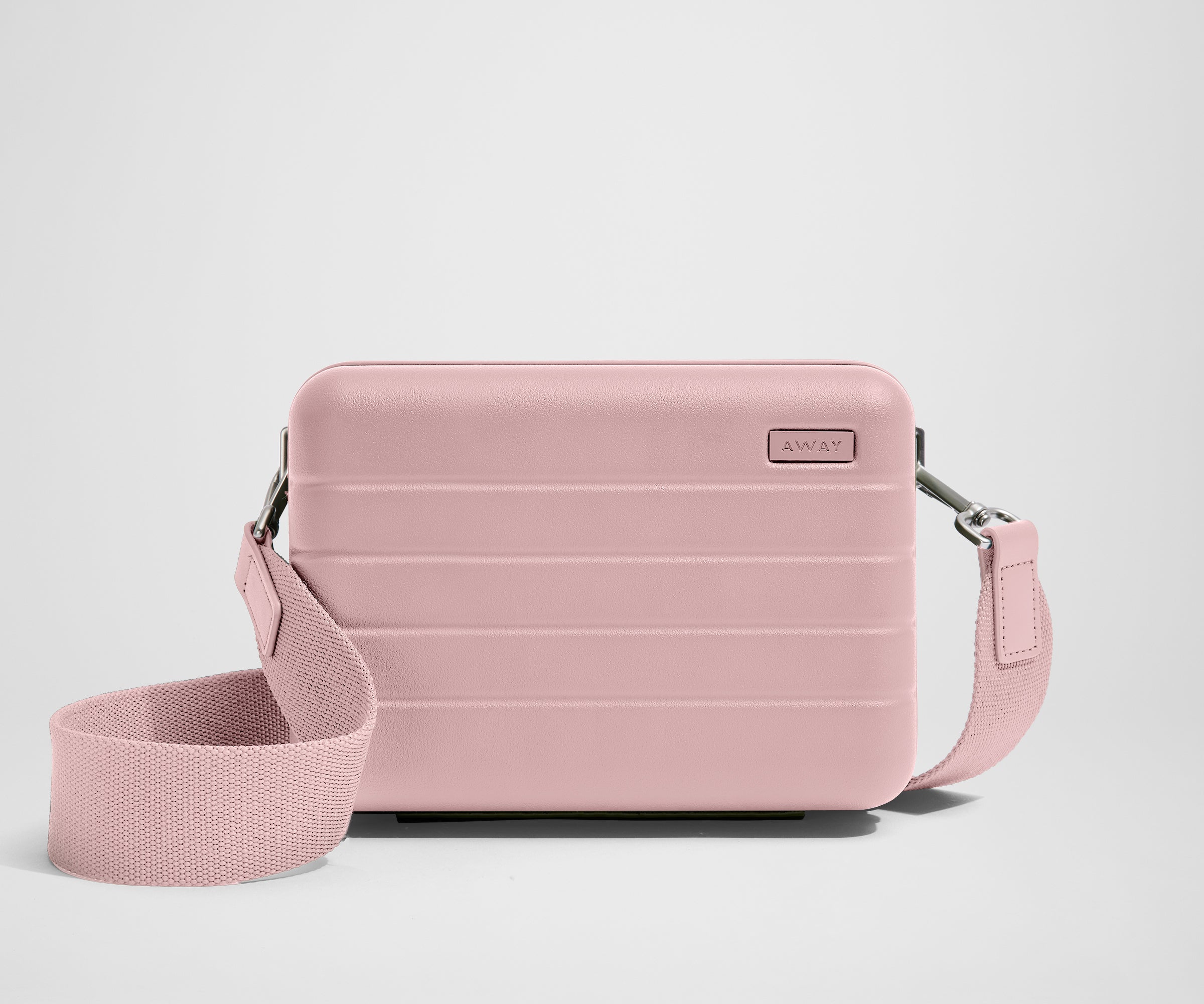 Pink crossbody bag on a light gray background