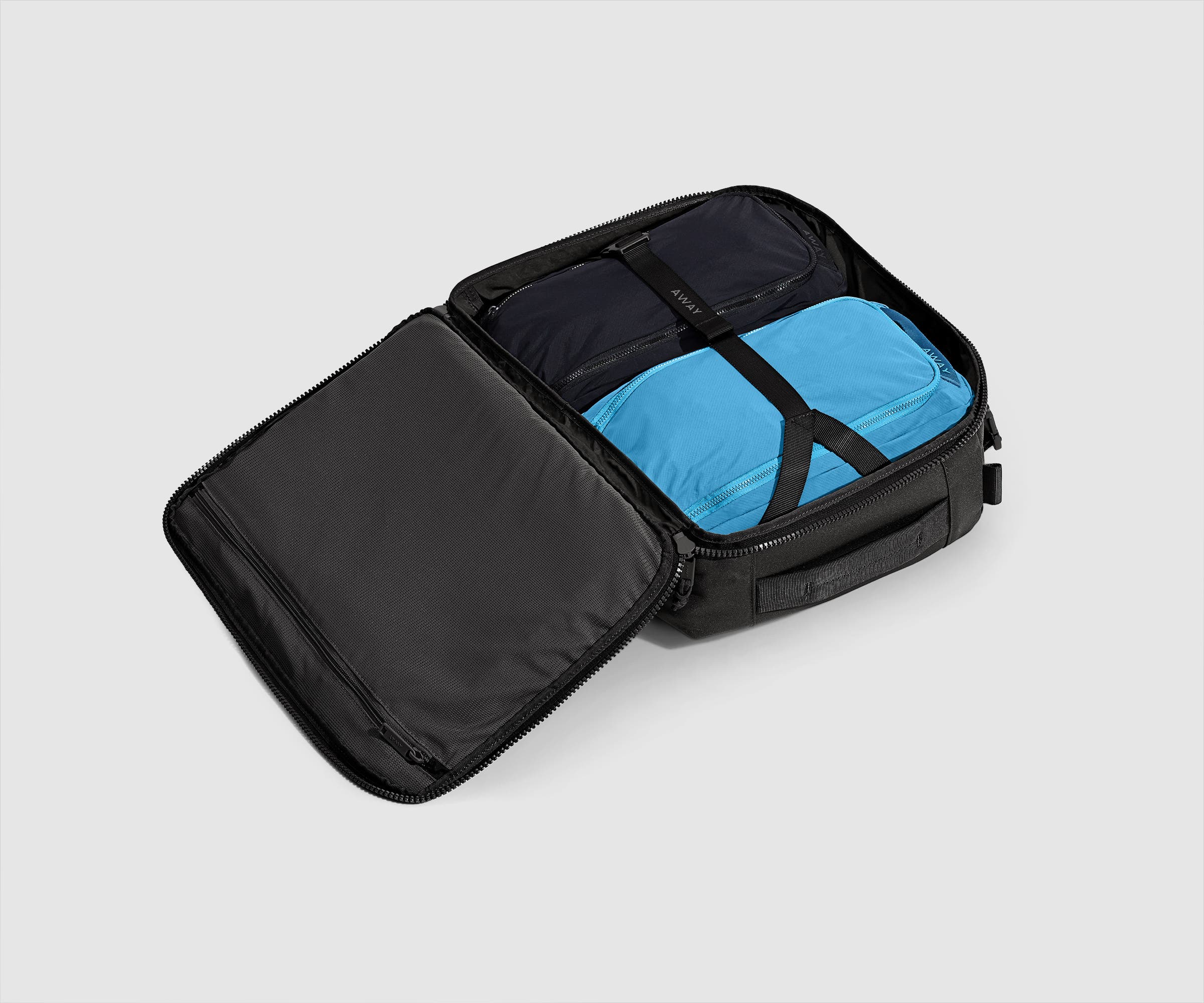 25L convertible backpack packed with two organizational cubes and secured with the compression strap