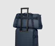 Back view of the Active Duffle 40L sitting on top of the Active Rolling Duffle 85L
