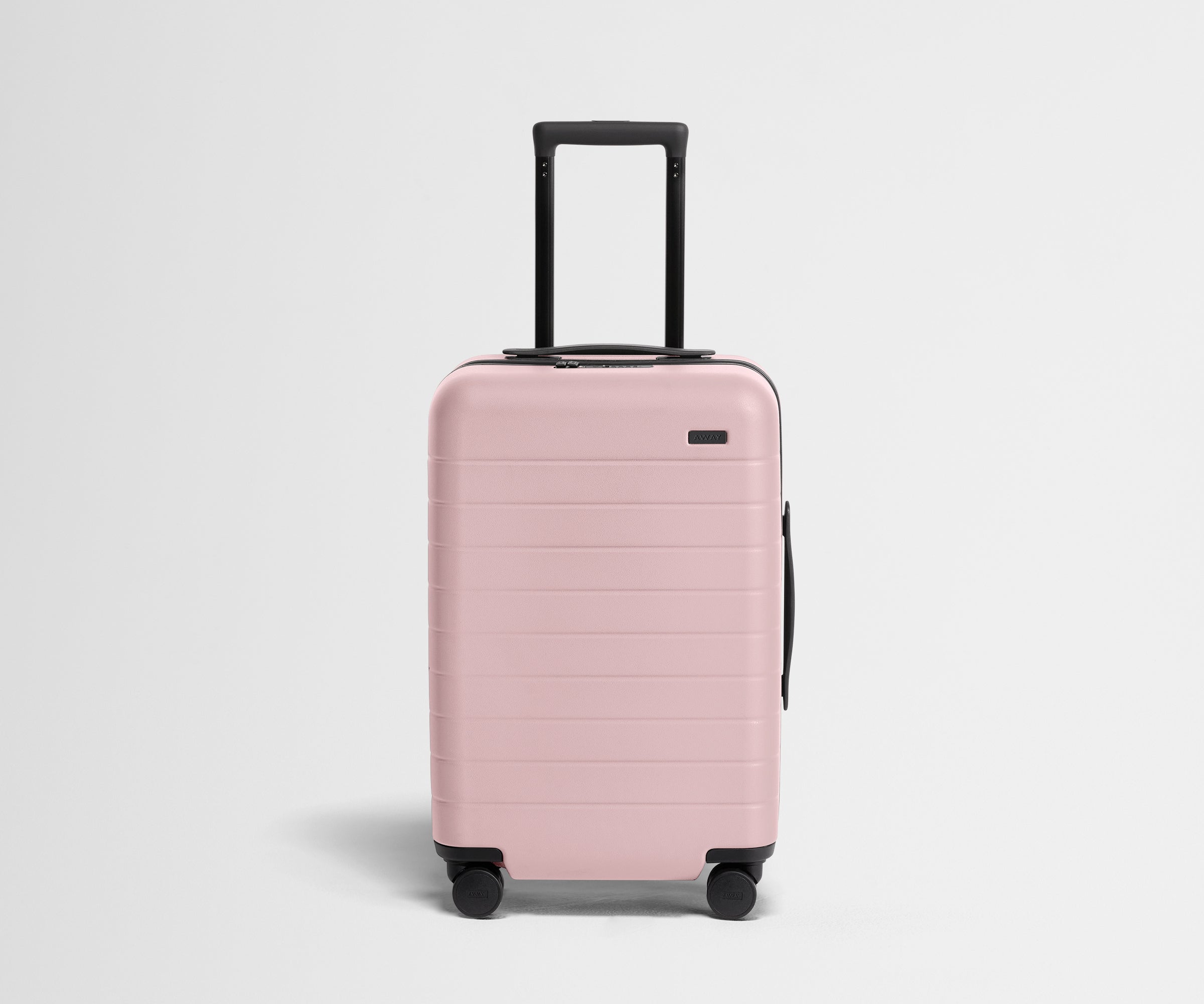 Pink suitcase with a black handle on a light gray background
