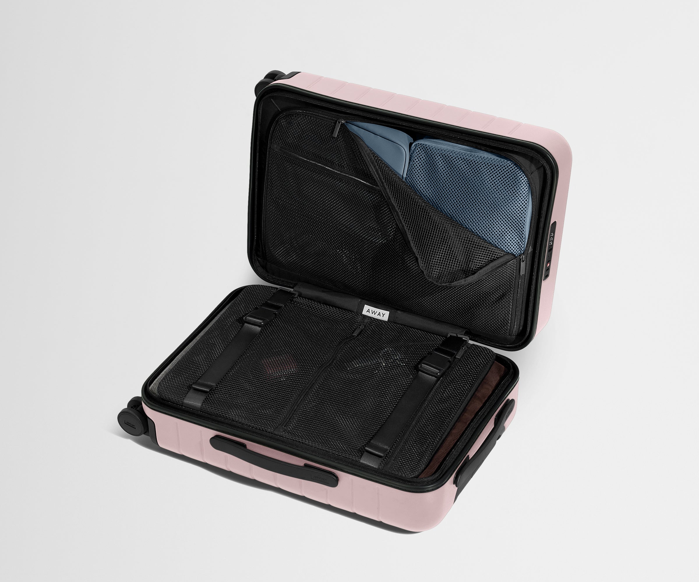 Pink suitcase with open compartment on a light gray background
