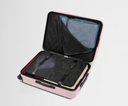 The Medium suitcase in Blush Pink shown open on its side and packed with Away's packing organizers to show capacity and the interior compression system, designed to help you pack more in