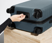The Carry-On suitcase in Coast Blue shown from below highlighting the underside grab handle