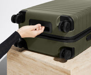 The Carry-On suitcase in Olive Green shown from below highlighting the underside grab handle