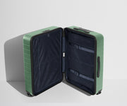 The Medium suitcase in Sea Green shown open in an upright position to show interior organization and compression system