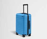 Angled product view of The Bigger Carry-On suitcase in Splash Blue