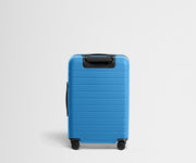 Back product view of The Bigger Carry-On suitcase in Splash Blue