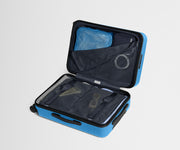 The Bigger Carry-On suitcase in Splash Blue shown open on its side and packed with Away's packing organizers to show capacity and the interior compression system, designed to help you pack more in