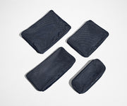 Set of four unpacked Packing Cubes laying flat