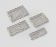 Set of four unpacked Packing Cubes laying flat