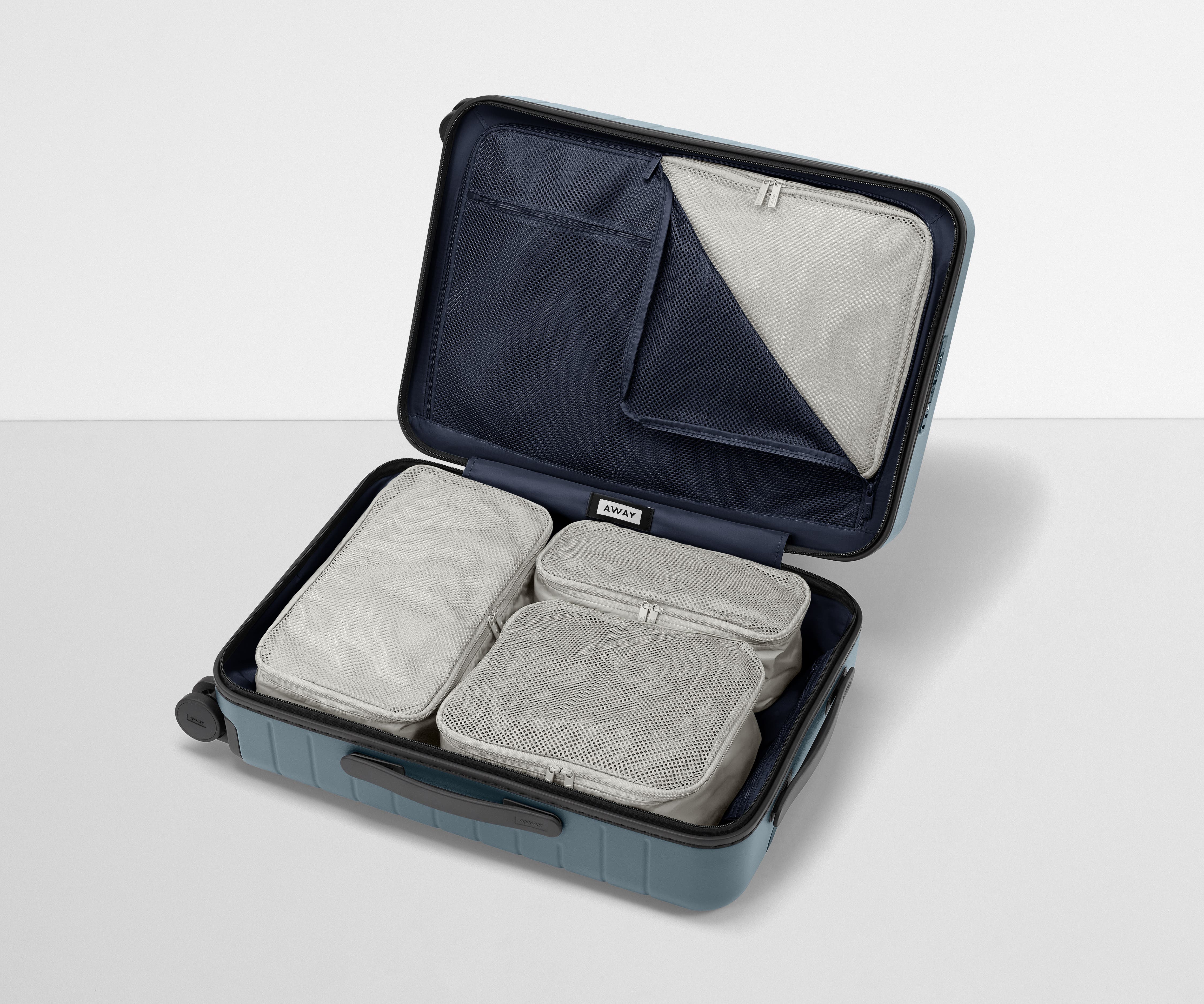 Four Insider Packing Cubes shown inside The Bigger Carry-On