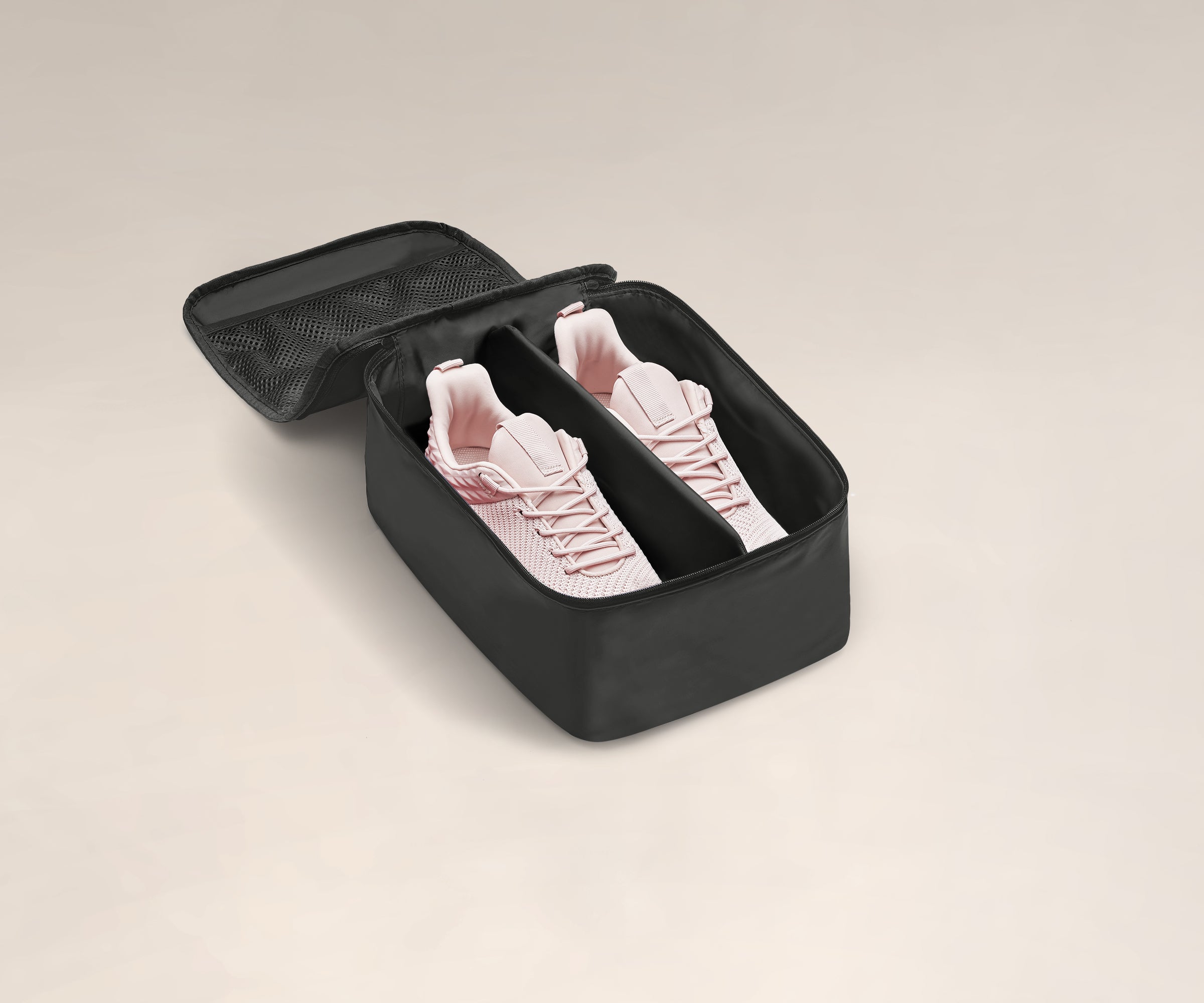 A pair of sneakers in a small Shoe Cube