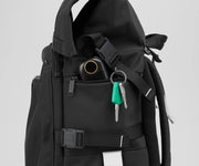 Close up view of a hand warmer and keys in the side zip pockets