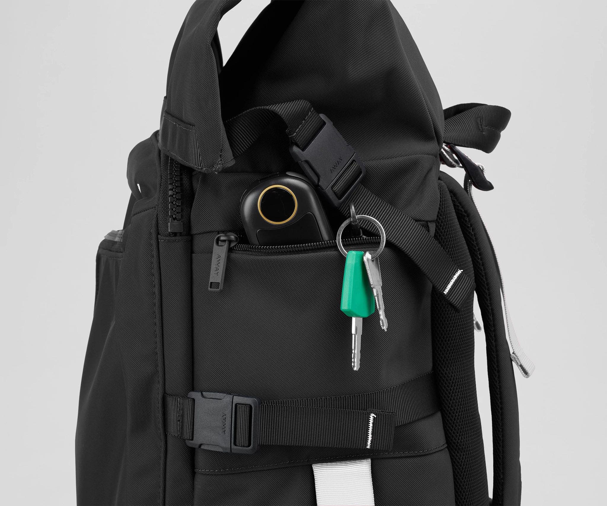 Close up view of a hand warmer and keys in the side zip pockets