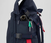 Close up view of a hand warmer and keys in the side zip pockets