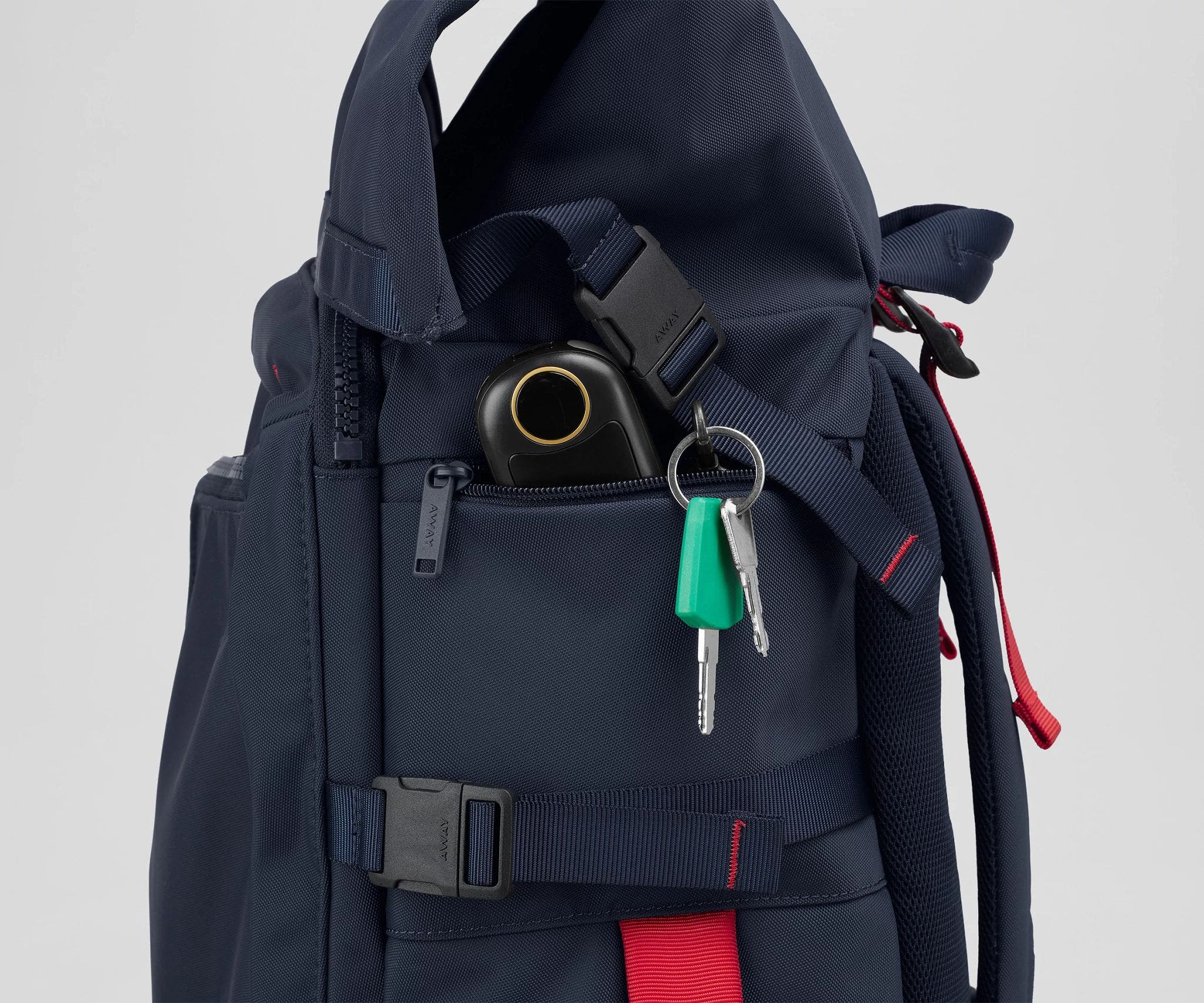 Close up view of a hand warmer and keys in the side zip pockets