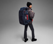 5'9" person wearing the 55L Boot Bag and winter clothes