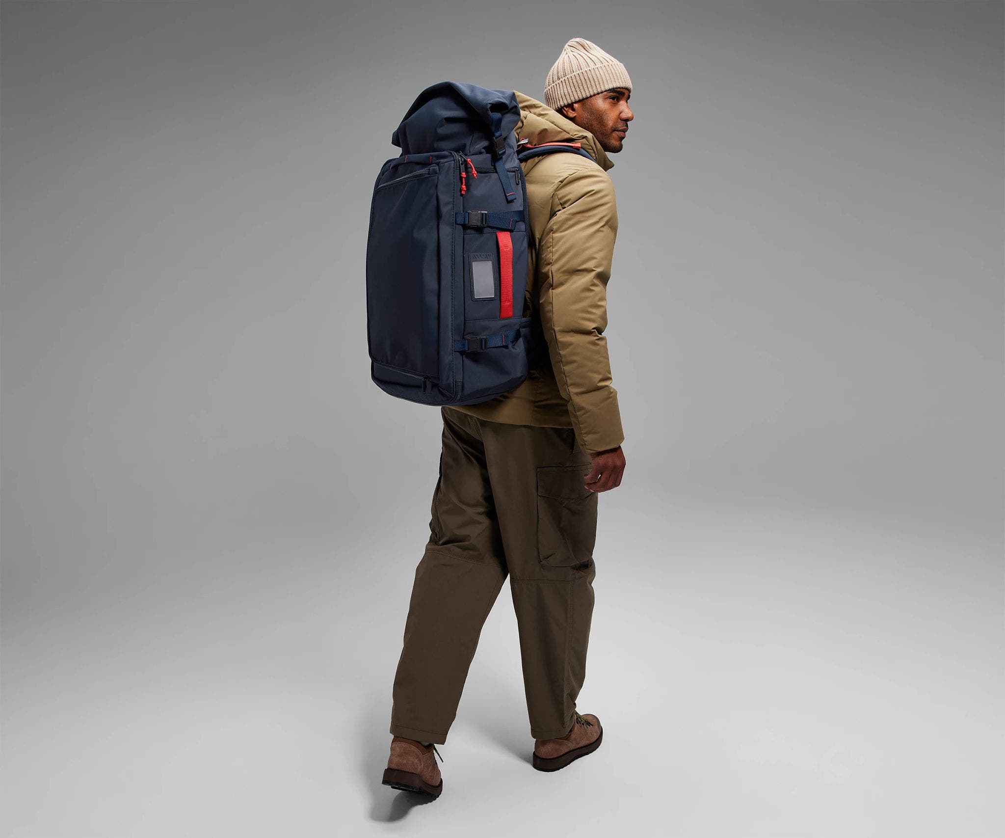 6'2" person wearing the 55L Boot Bag and winter clothes