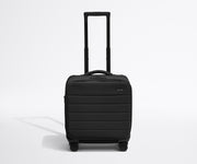 Front product view of The Softside Compact Carry-On suitcase in Jet Black with raised handle