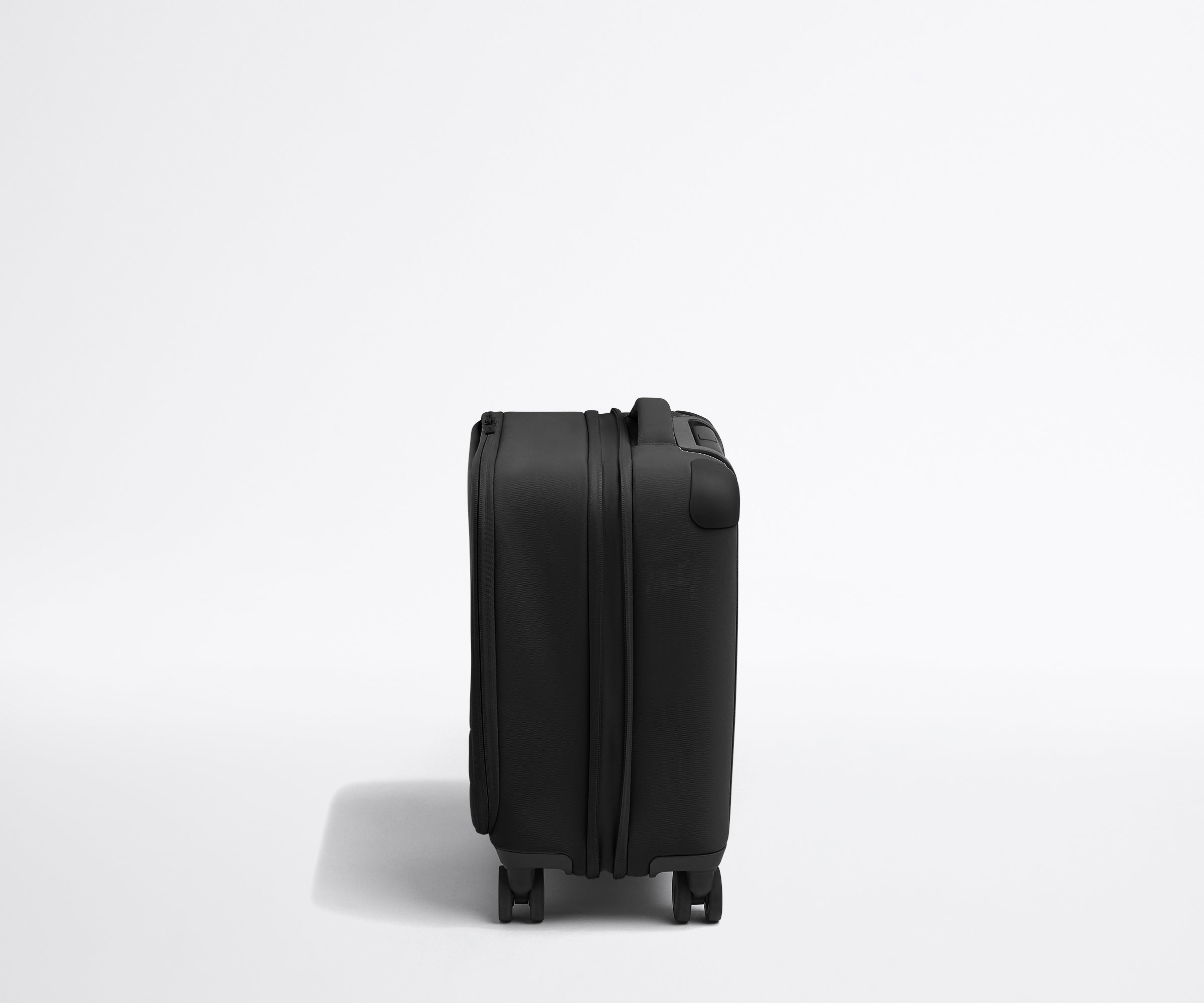 Side product view of The Softside Compast Carry-On suitcase in Jet Black shown fully expanded
