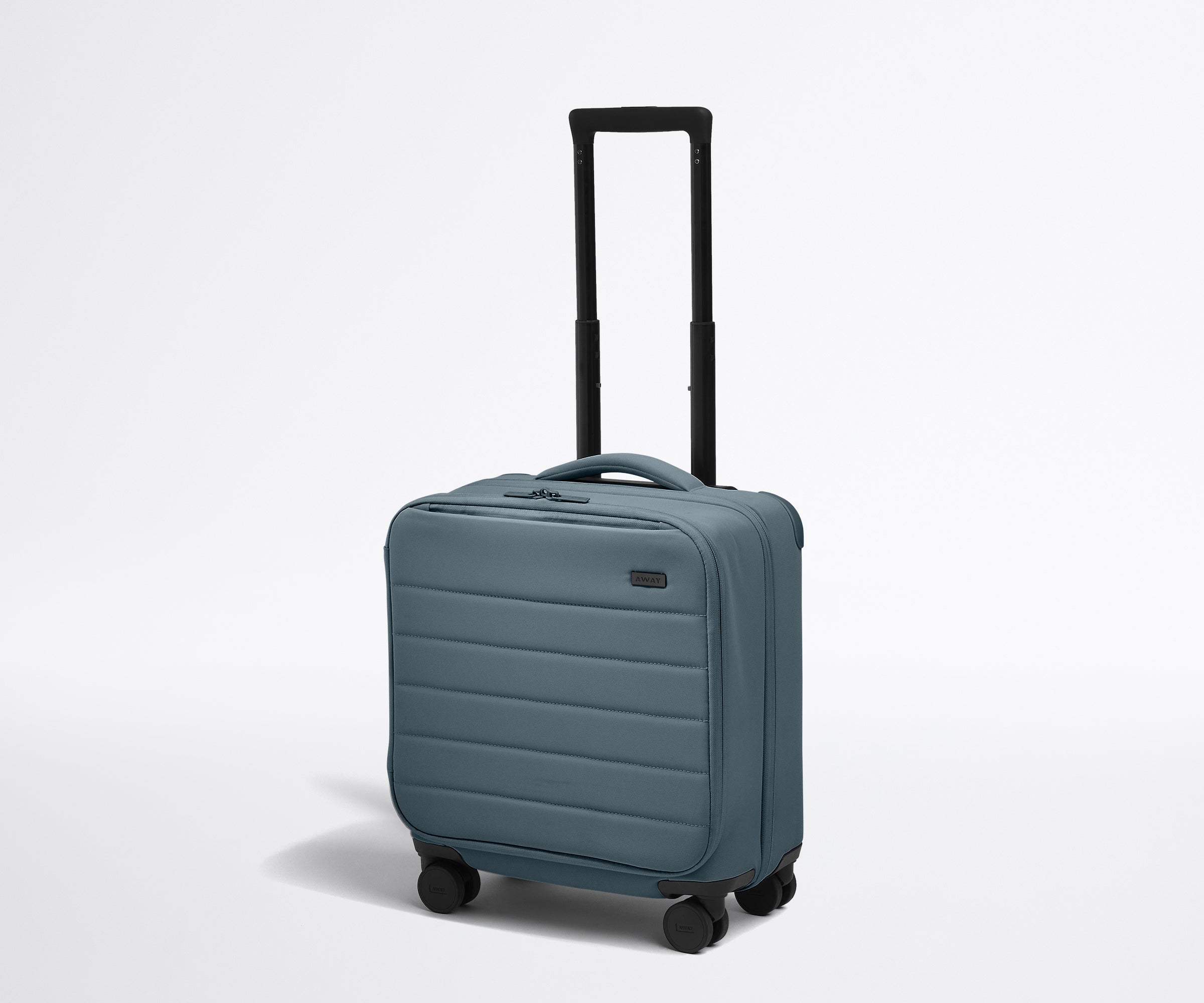 Angled product view of The Softside Compact Carry-On suitcase in Coast Blue with raised handle