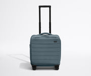 Front product view of The Softside Compact Carry-On suitcase in Coast Blue with raised handle