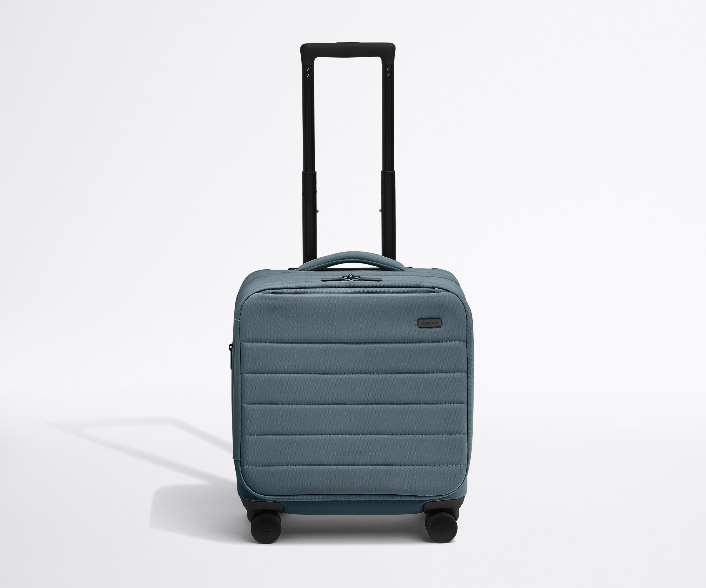 Front product view of The Softside Compact Carry-On suitcase in Coast Blue with raised handle